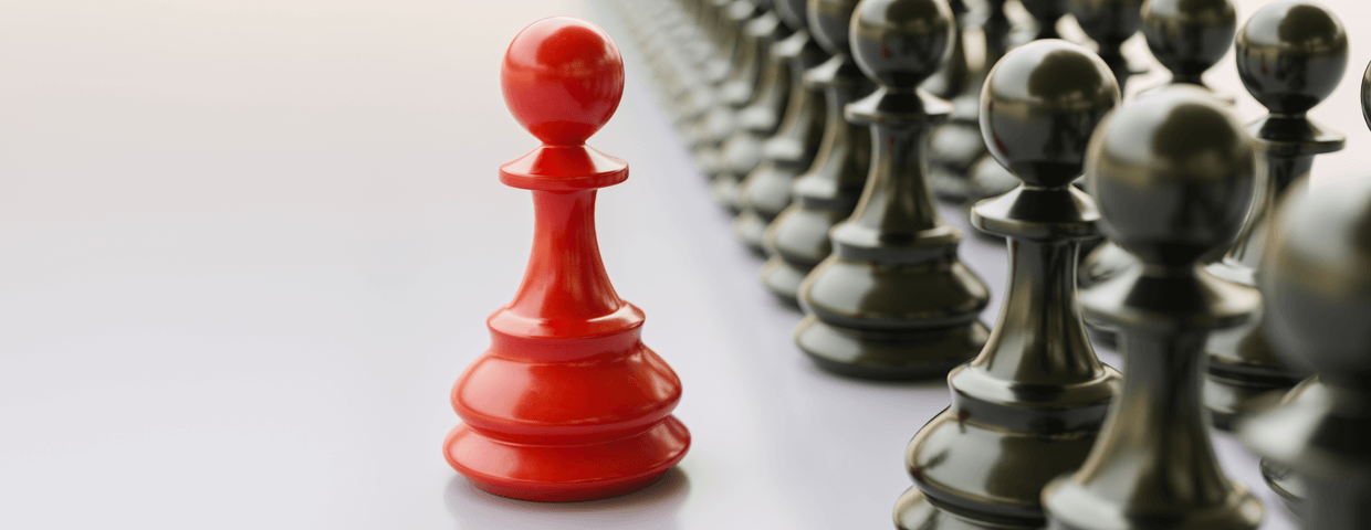 Leadership concept, red pawn of chess, standing out from the crowd of blacks