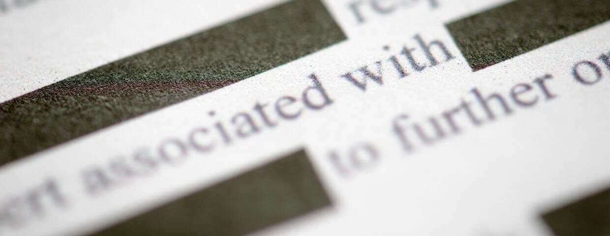 close up of printed document with parts redacted